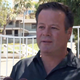 Gordon in front of his childhood home where his father and stepmother were found deceased. (Image via KCBS screengrab)